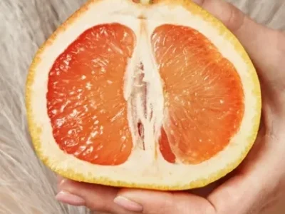 half-of-a-cut-grapefruit-in-a-female-hand-symboli-2023-11-27-05-06-16-utc-Medium-e1716569444653
